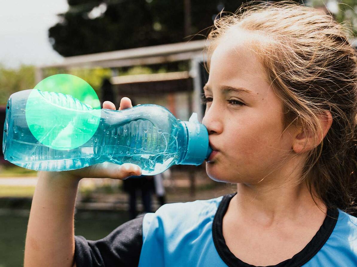 girl drinking from drinking bottle