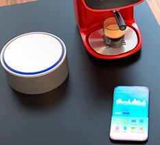 Smartphone og højtaler på bord der kan forbinde trådløst ved enten Wifi eller Bluetooth