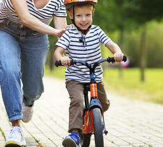 Barn cykler på en løbecykel