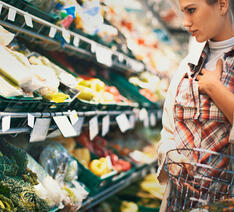 Kvinde køber ind og ser stigende priser i supermarkedet