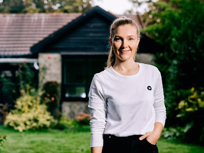 Kvinde foran sit hus