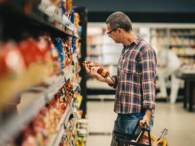 emballagen kan snyde - mand i forretning kigger på produkt